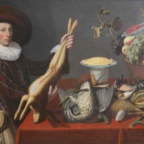 A Game Still Life with a Young Man Holding a Hare in front of a Table with other Victuals,Dutch