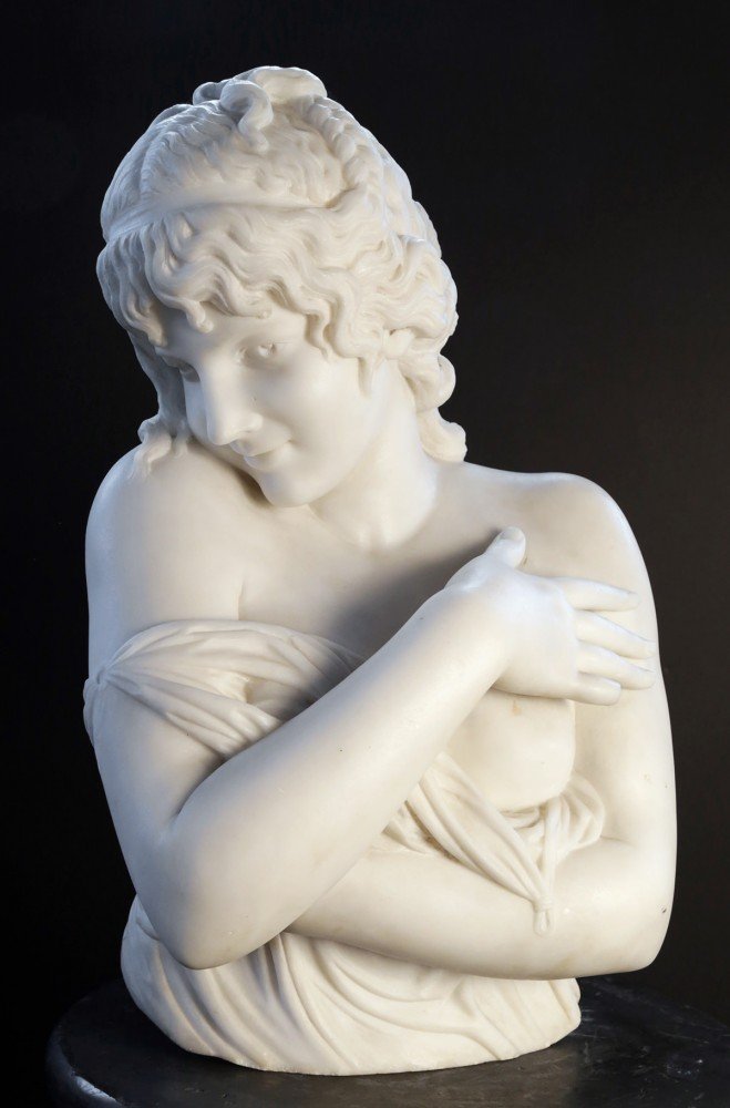 A Carved Marble Bust of a Demure Young Girl